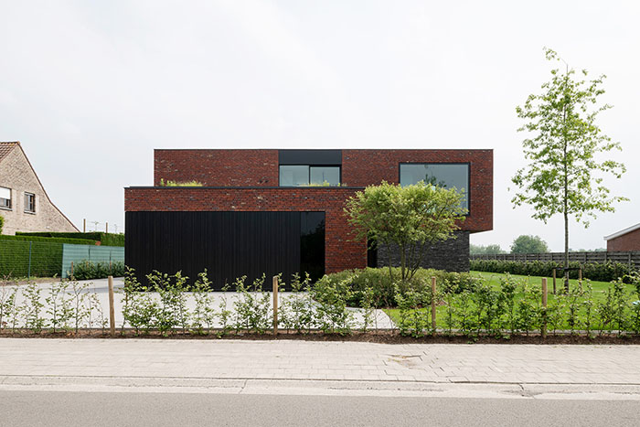 Moderne woning met elegant zwart aluminium schrijnwerk aan de buitenzijde.